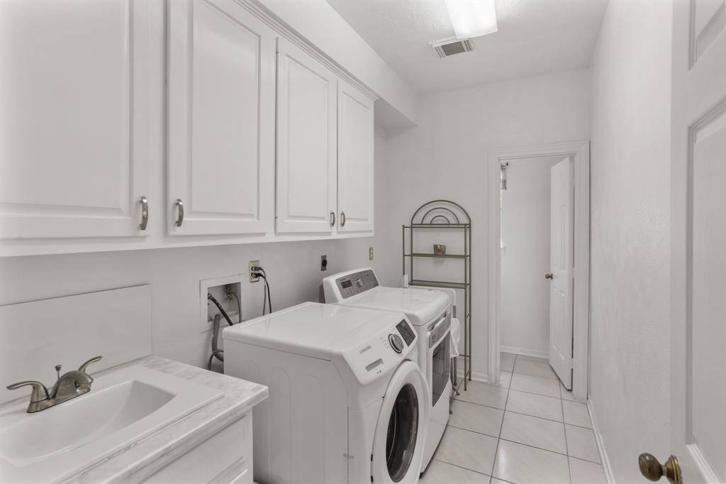 Extra large utility room with sink and also has the 2nd half bath