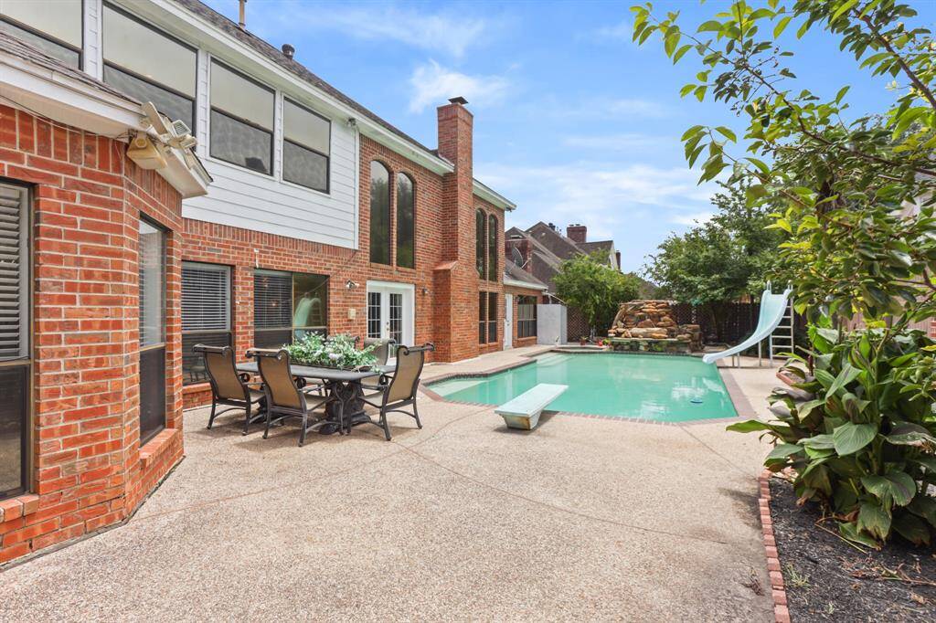 Outside has a wonderful pool with slide, diving board and custom natural rock waterfall.
