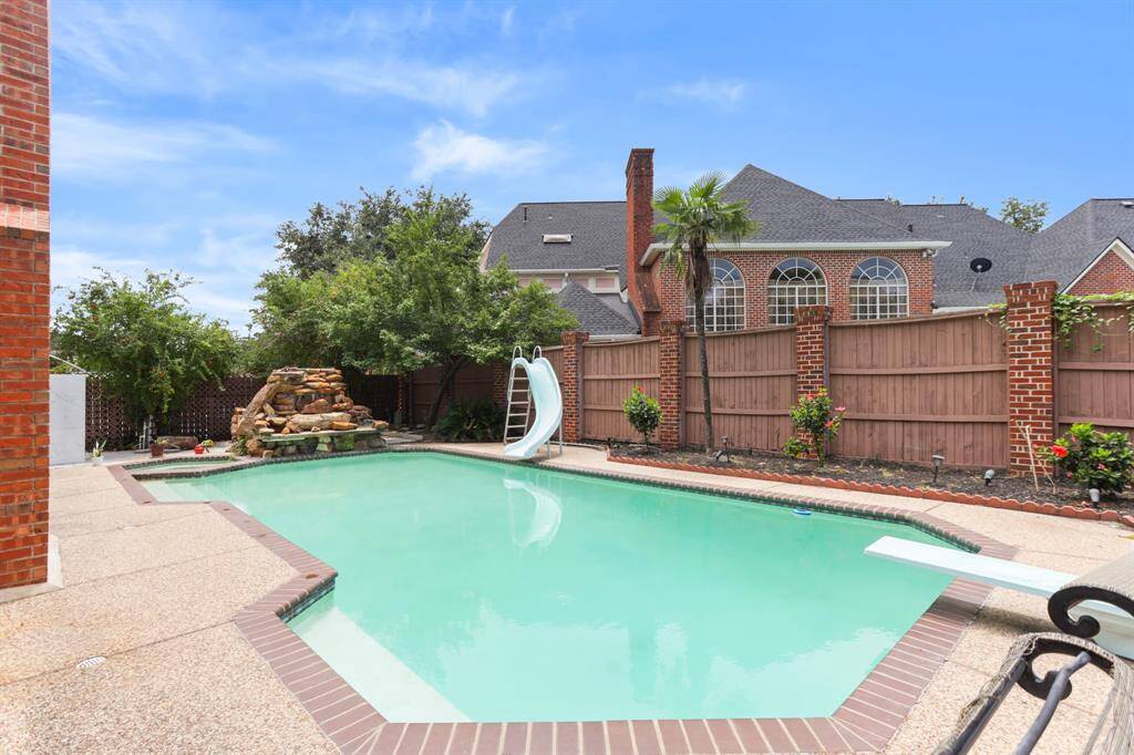 All brick home with many fruit trees, outdoor shower, pool/spa and yoga area for all your summer enjoyment.