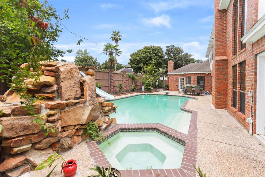 Custom outdoor shower conveniently located by spa/pool and the French doors off Primary bedroom.