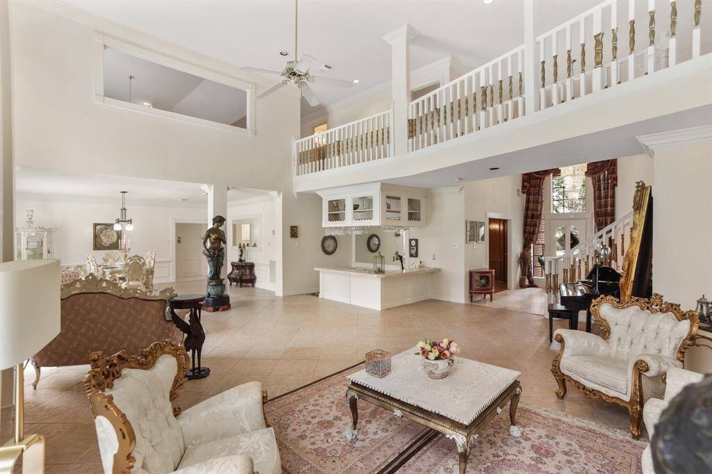 High ceilings, tile floors, custom window treatments, gas log fireplace and custom mantel featuring elegant mirror are just a few of the many amenities that await you.