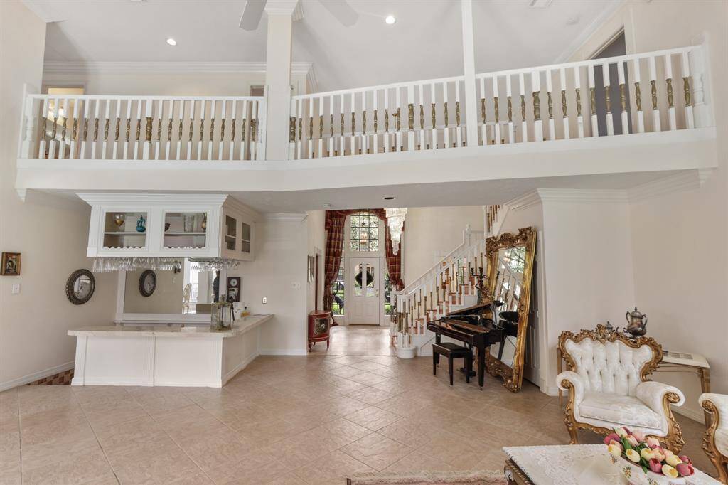 If you love to entertain this is your next home!  It features two formal living areas, custom mill work and the step down bar with sink.