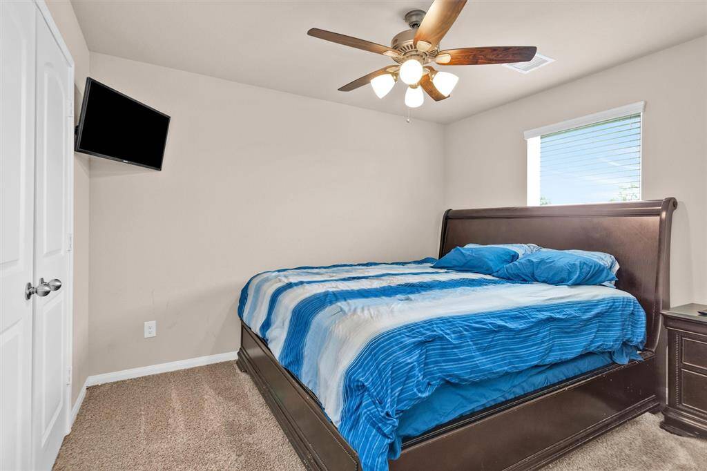 Bedroom #2 offers neutral paint & carpet with a nice-sized window and a ceiling fan to keep the room cool.