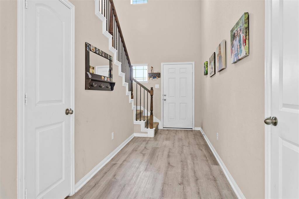 This home features vinyl wood plank flooring on the 1st floor & wrought iron spindles on the staircase!