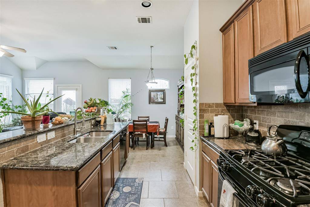 Kitchen has island with sink and lots of storage
