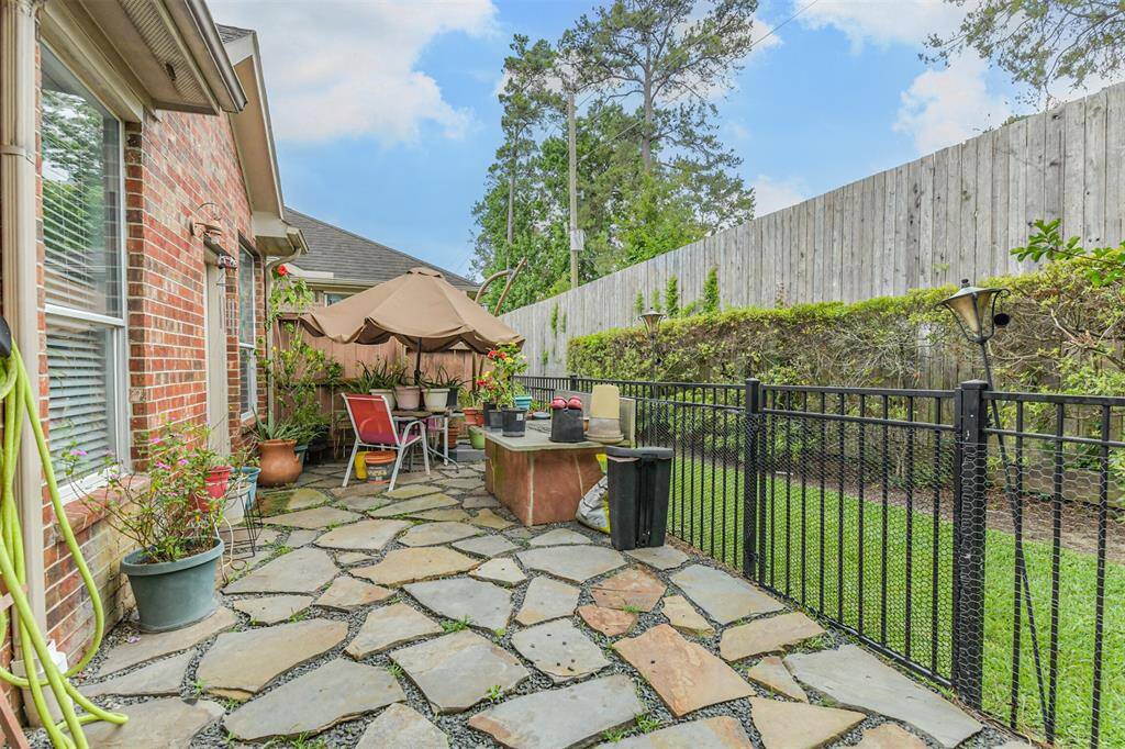 paved back patio with wrought iron gate