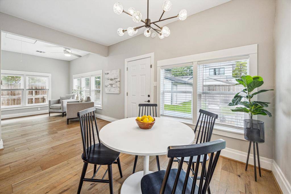 The breakfast area is anchored by a stylish chandelier and overlooks the backyard.