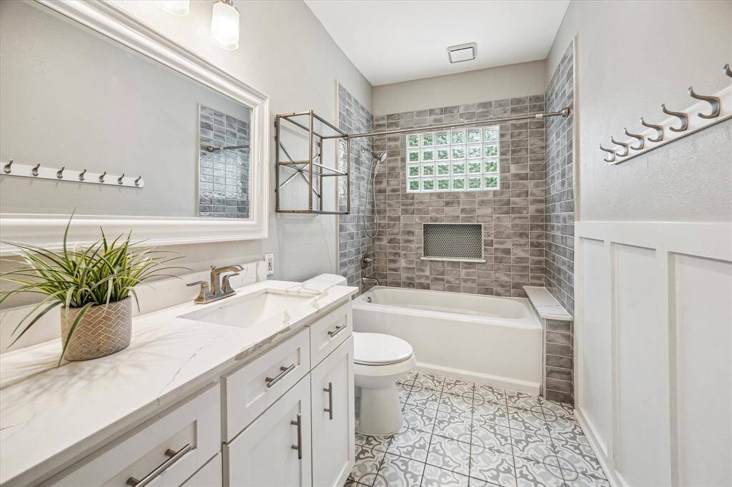 Full bathroom for two of the secondary bedrooms with quartz counters, stylish tile and a shower/tub combo.