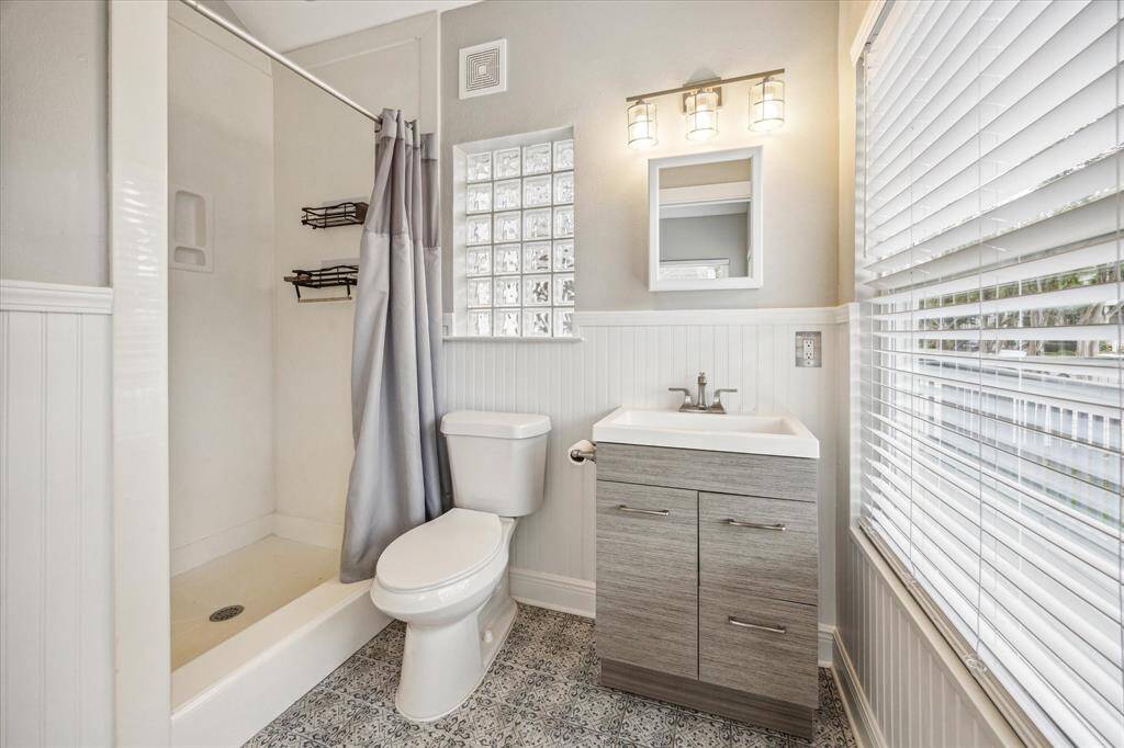 Ensuite bathroom for the front bedroom with a shower, stylish tile and great natural light.