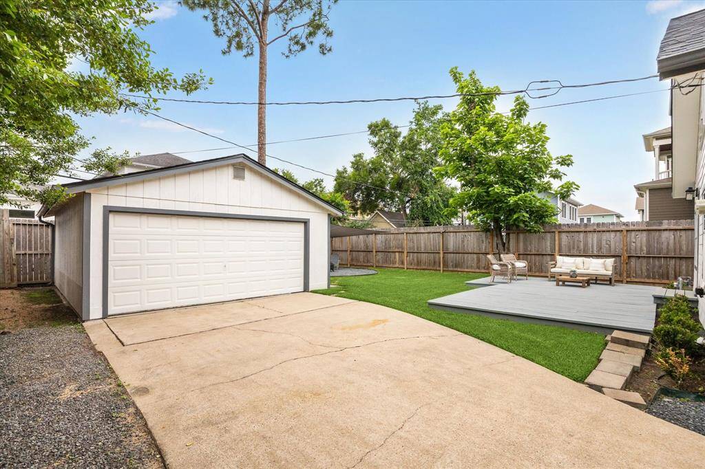 Two car garage at the end of a long driveway.