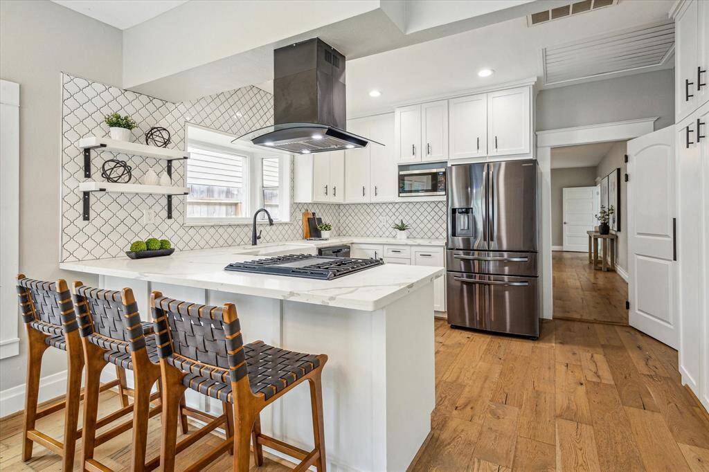 The breakfast bar is the perfect spot for casual meals or chatting with guests while hosting.