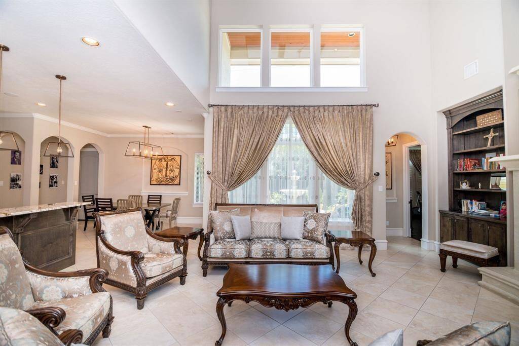 Expansive living room with a large window showcasing beautiful backyard views.