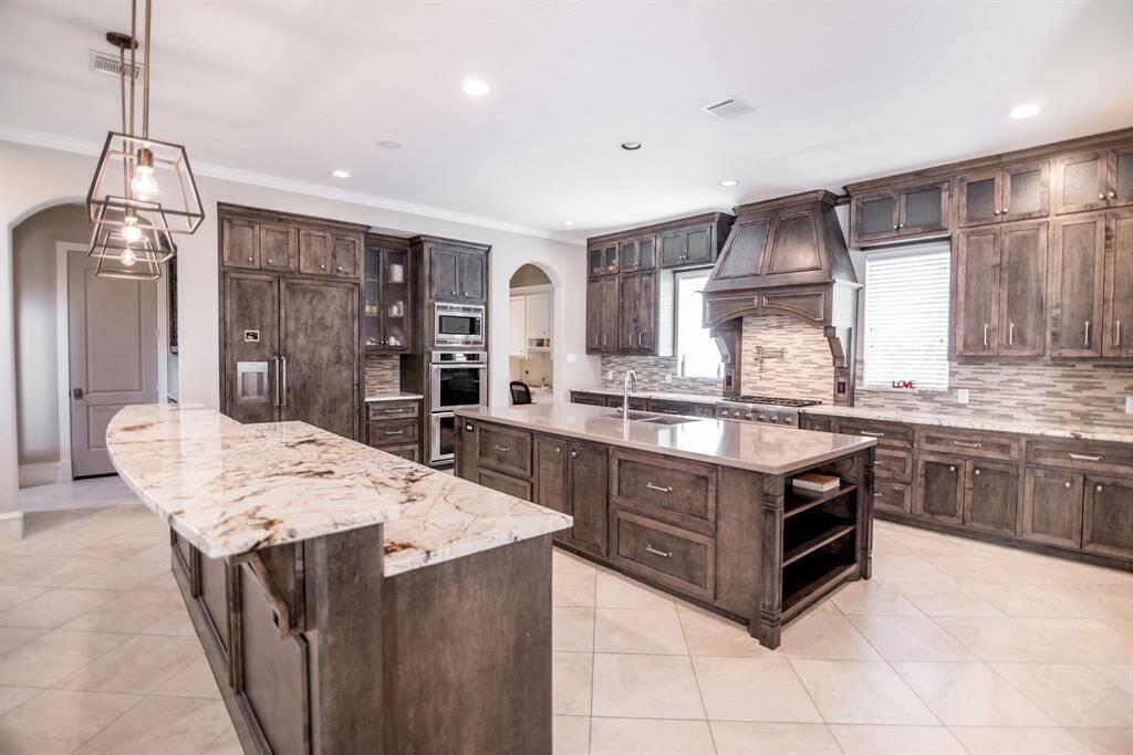 Experience the elegance of a kitchen featuring a seamlessly integrated wood-paneled refrigerator.