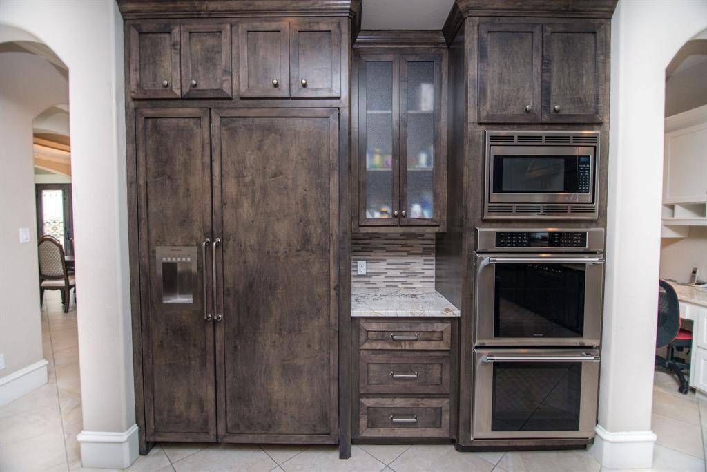 Sophisticated cabinetry with built-in double ovens for seamless cooking and ample storage.