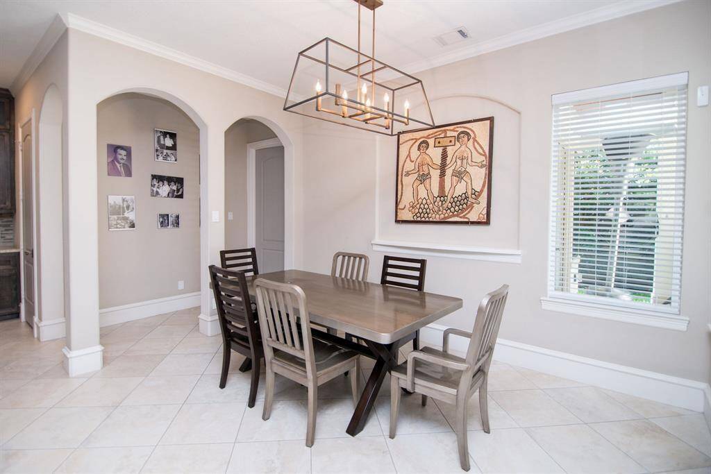 Expansive breakfast nook with scenic backyard views.