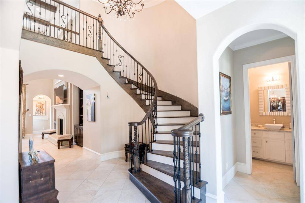 Elegant, sweeping staircase adds a touch of luxury and charm.