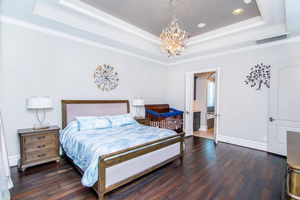 Luxurious bedroom featuring a stylish primary bathroom, combining comfort and elegance.