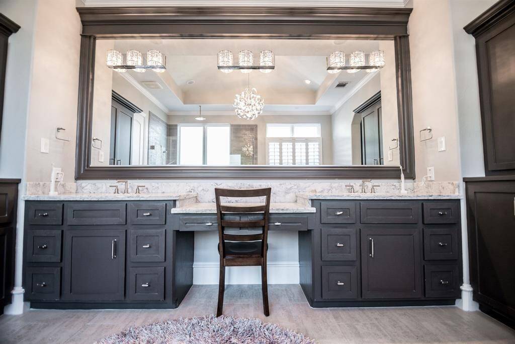 Experience luxury with dual sinks, generous storage, and sophisticated lighting.