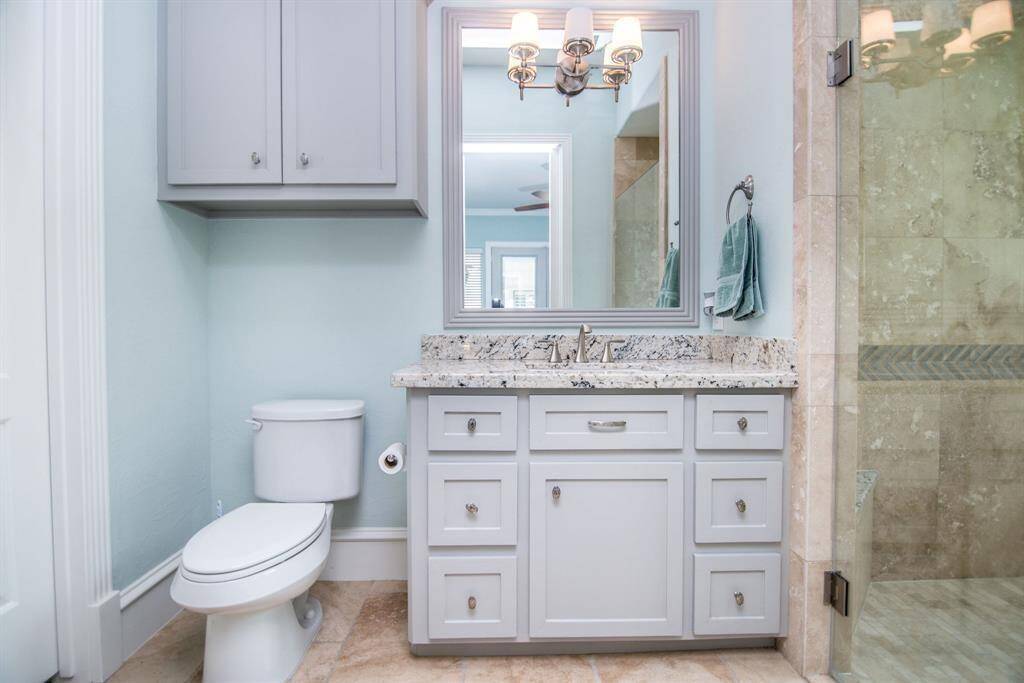 Luxurious, granite-finished bathroom with wheelchair accessibility.