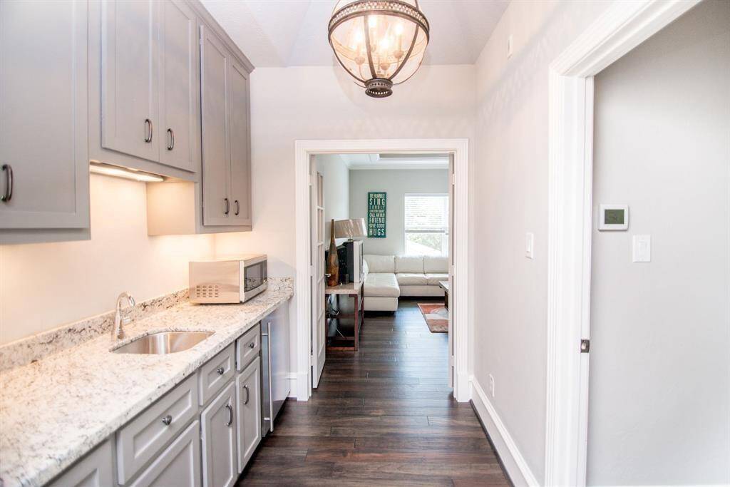 Charming kitchenette with sleek cabinetry and elegant countertops, offering a cozy and functional space.