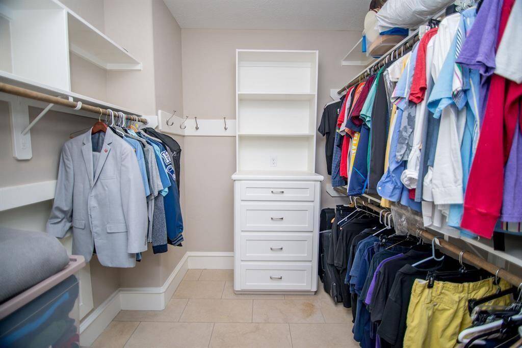 Expansive walk-in closet with ample storage and organized shelving.