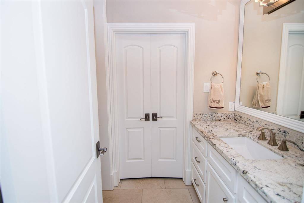 Luxurious bathroom featuring elegant granite countertops and modern fixtures.