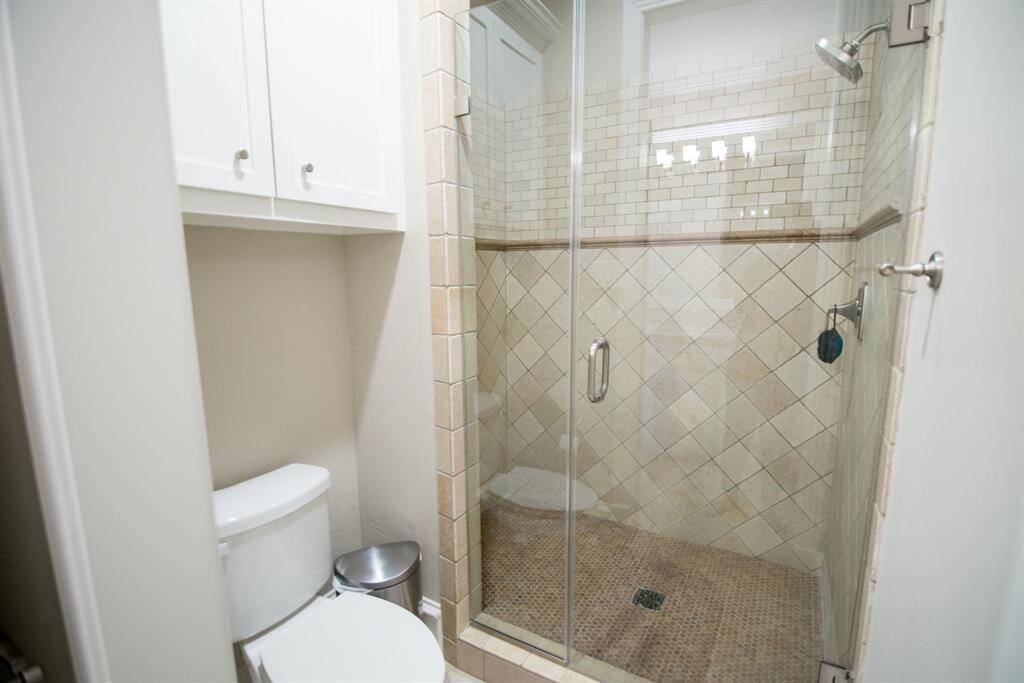 Spacious, elegantly tiled shower offering a luxurious bathing experience.
