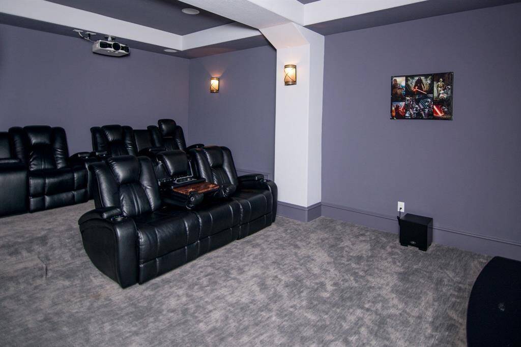Relax in luxury with plush seating in this inviting media room.