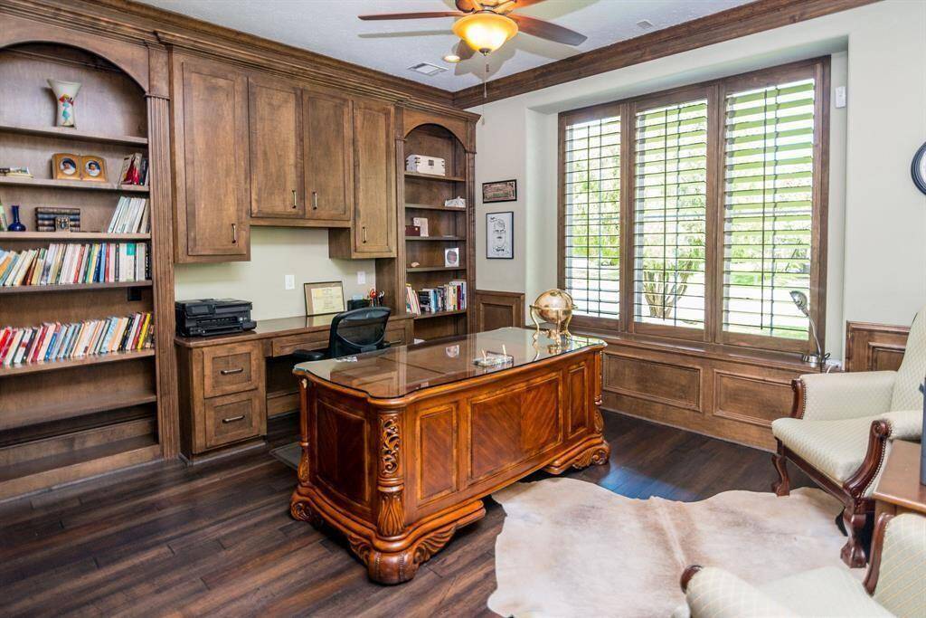 Bright office with serene front yard views.