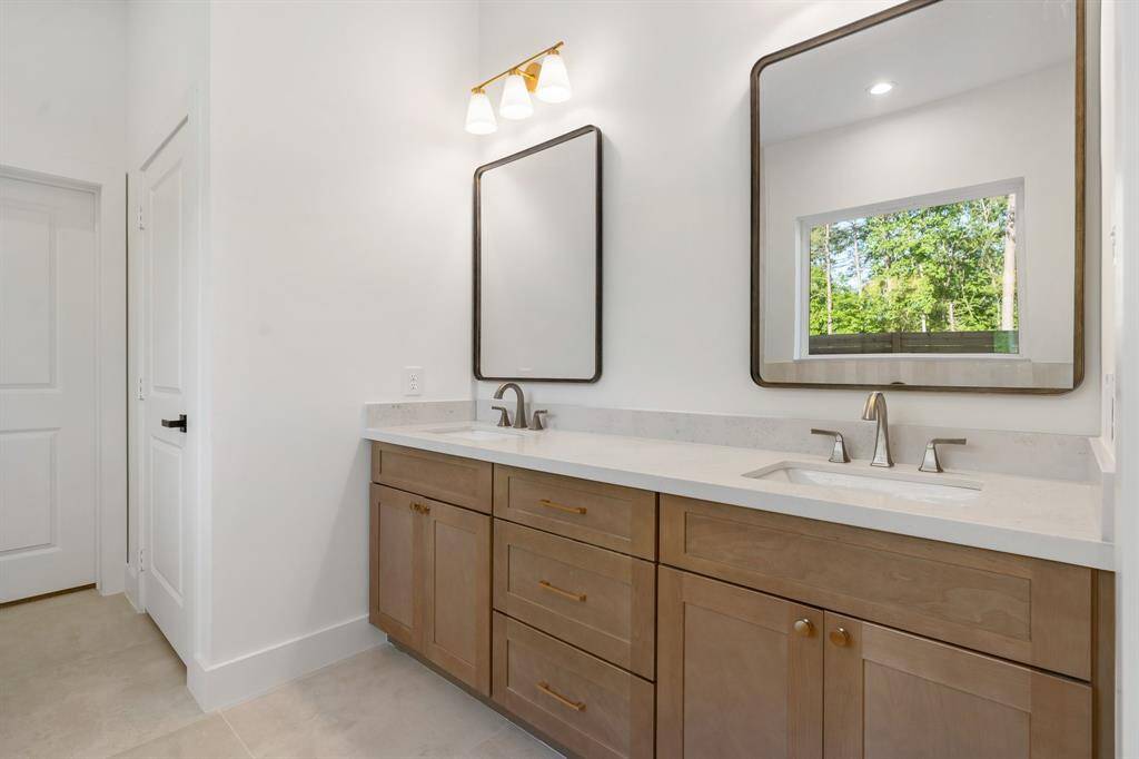 The elegant, spa-like primary bathroom boasts high-end finishes and a large walk-in closet.
