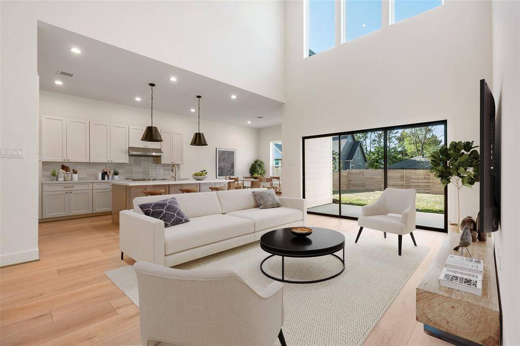As you walk in, the first floor boasts an open-concept layout with soaring ceilings, abundant natural light, and a beautifully designed kitchen featuring high-end finishes and a spacious walk-in pantry. Virtually staged.