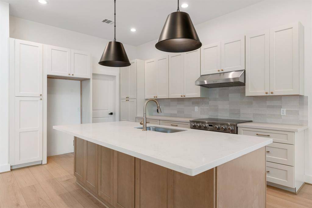 Designer touches and upscale fixtures add a sophisticated flair throughout.