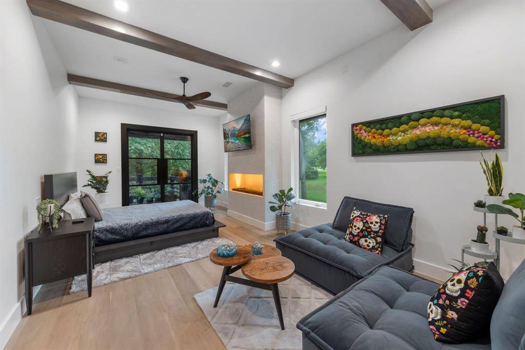 On the main level (2) is a spacious guest suite with a sleek fireplace, sitting area, patio access and en-suite bathroom.