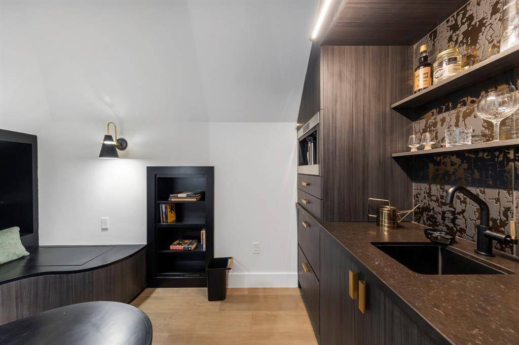 Tucked behind the bed is a cozy sitting nook paired with a stylish wet bar.