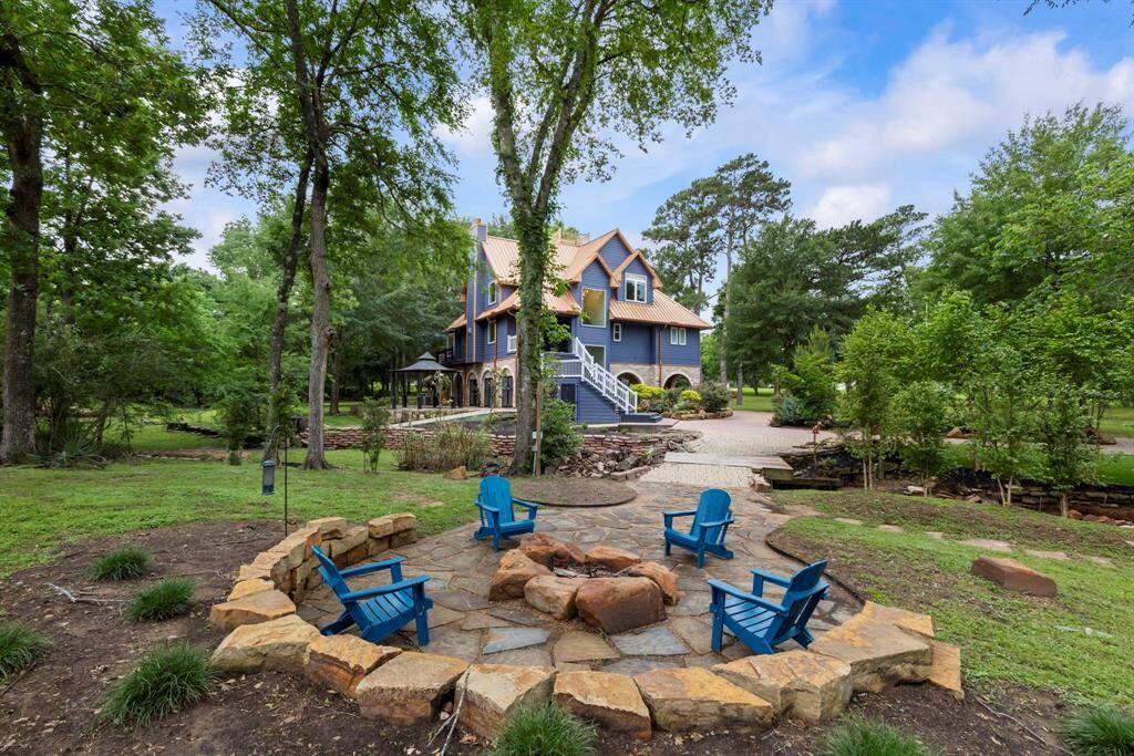 The expansive and secluded lot includes a beautifully crafted stone firepit for cozy evenings under the stars.