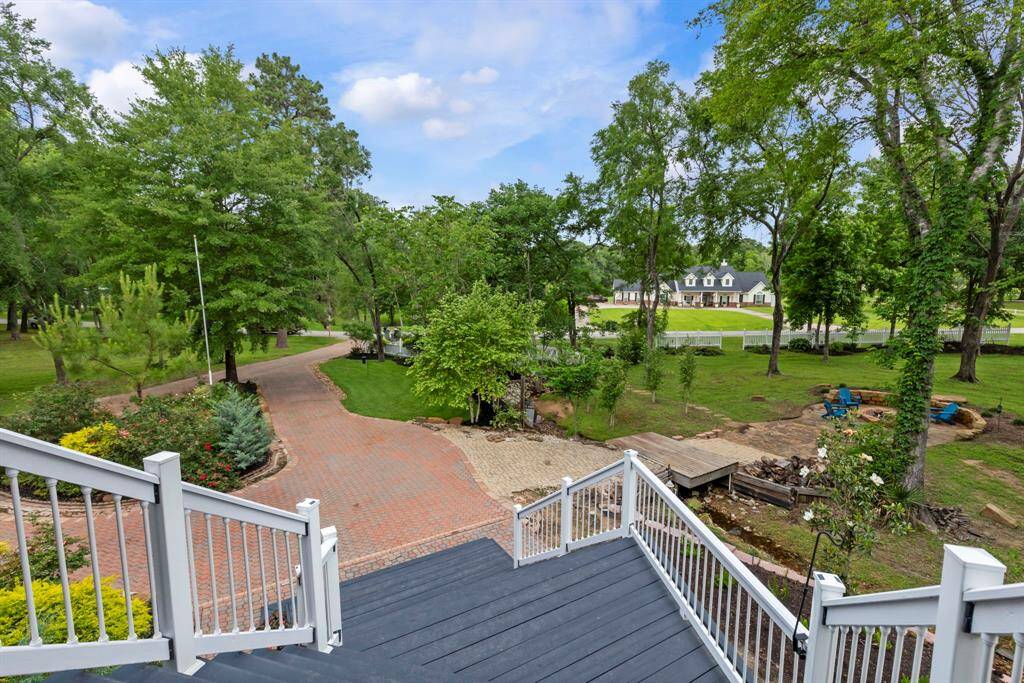 Meticulously manicured property with a stone circle driveway with ample parking.