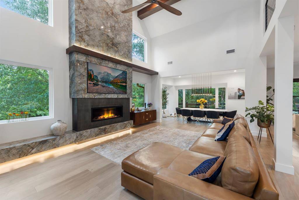 Open floor plan ideal for entertaining with walls of windows looking out to the trees.