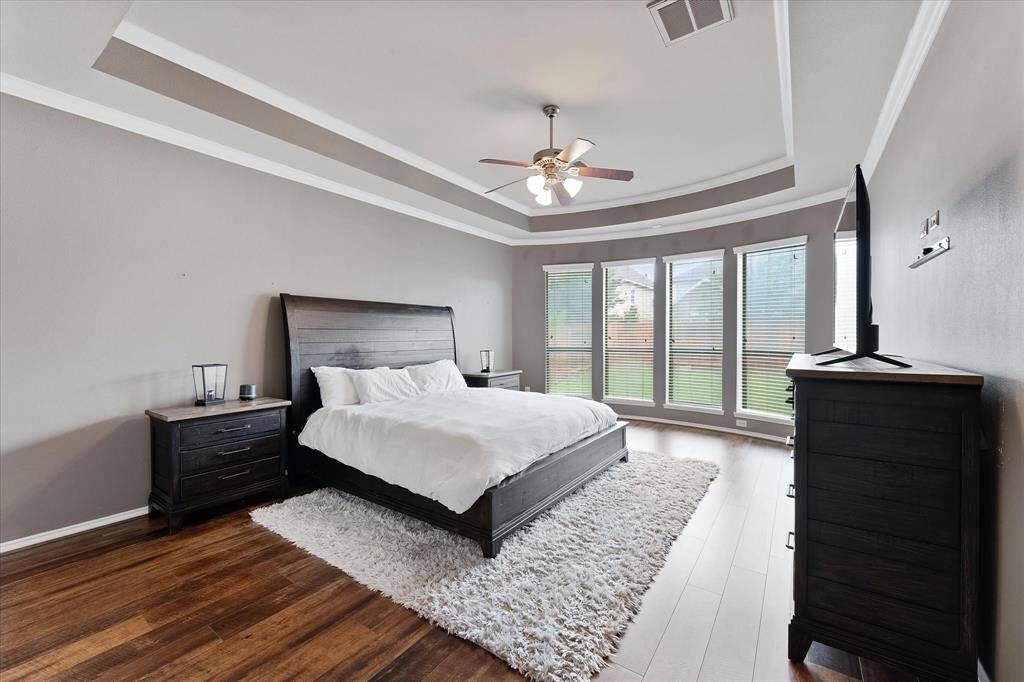 Private primary sanctuary with double tray ceiling