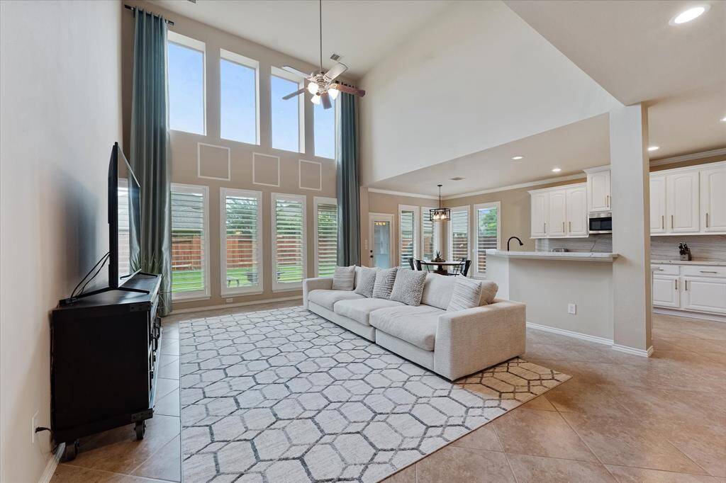 Natural light floods the living spaces from the wall of windows in the living room
