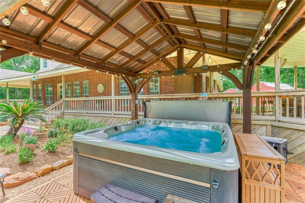 Enjoy the covered spa, year round, with Bluetooth speakers and close to the kitchen!