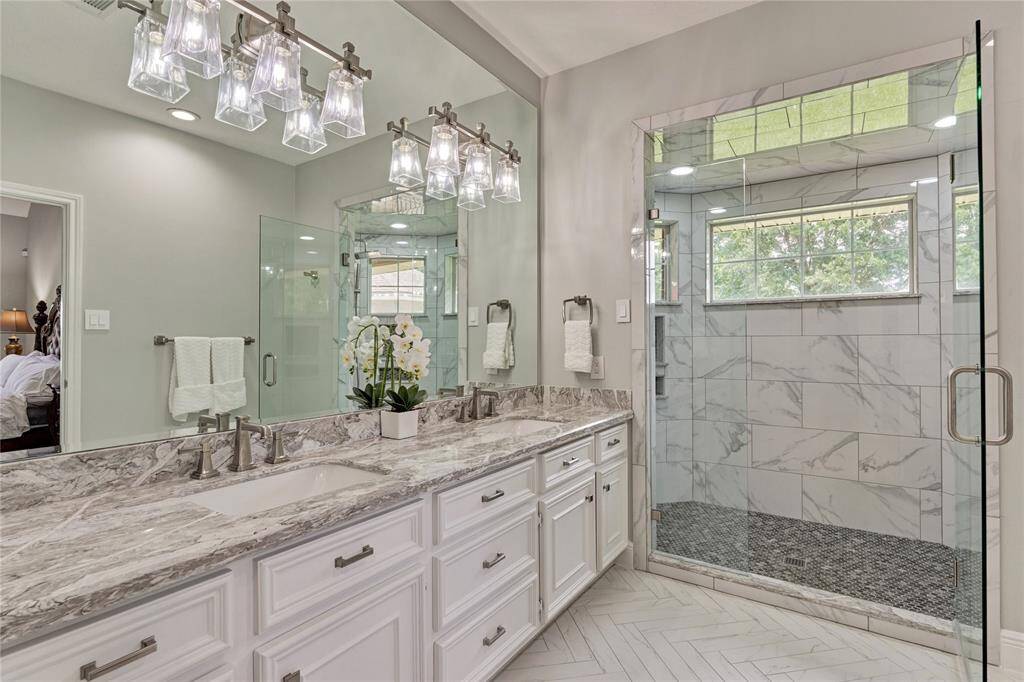 Completely remodeled bathroom with herringbone tile, quartz counters and panoramic window views