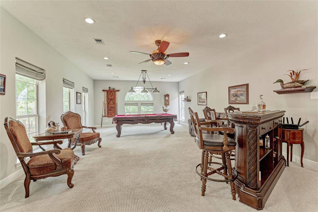 Billiard room with ample light, separation from the rest of the home and extensive wet bar