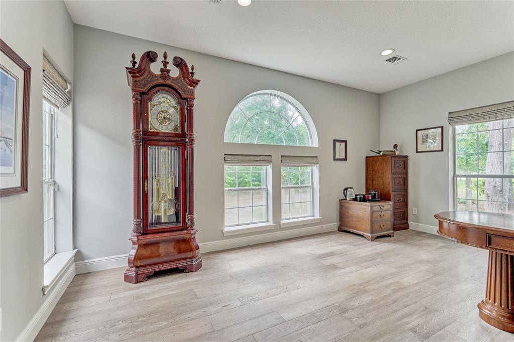 Large office with extensive natural light and LVP flooring, with sound proof walls for quiet study and work