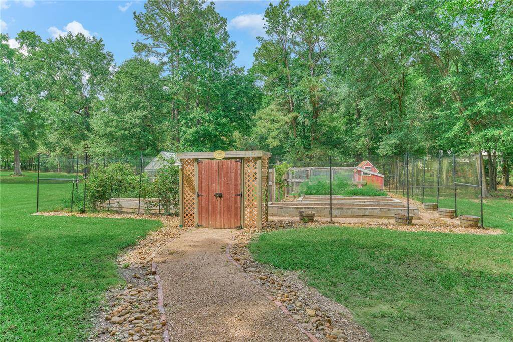Peaceful game-fenced garden and greenhouse