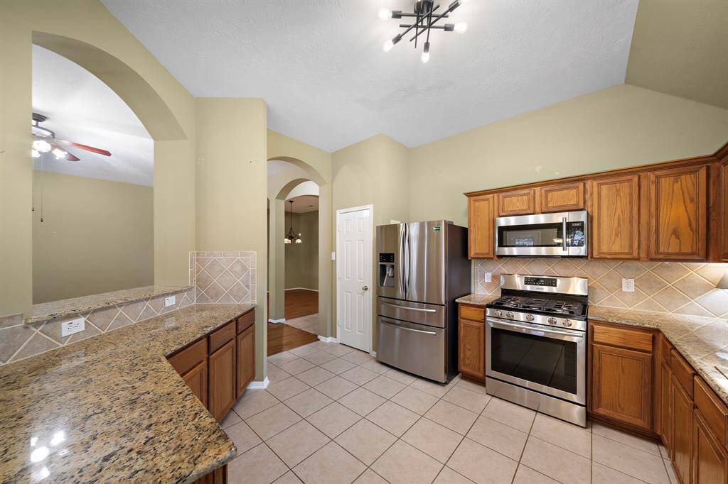 Ample countertop space, updated lighting, and a generous kitchen pantry.
