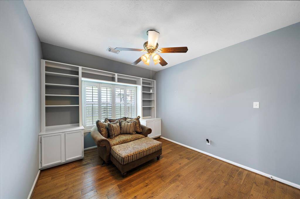 The library/study/home office is in the heart of the home across from the forming dining room. Double doors and built-in shelving make this a versatile, private space.