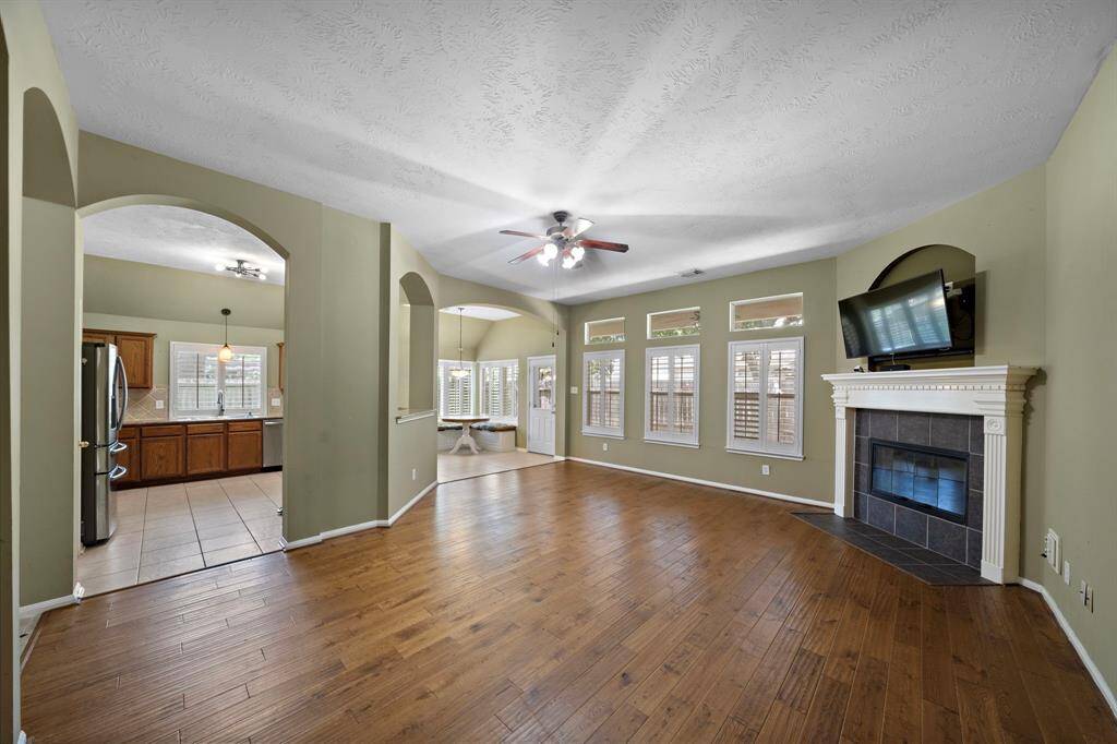 Gas log fireplace and gorgeous plantation shutters in the family room.
