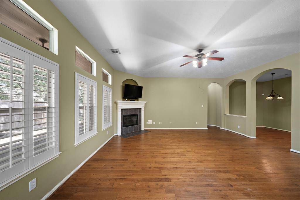 Large windows allow natural light to fill the family room and offers a view of the beautiful backyard space.