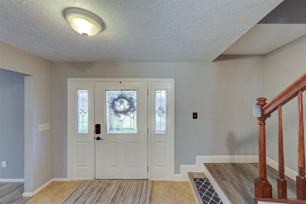 Front tiled entry features leaded glass door & side lights & keyless entry