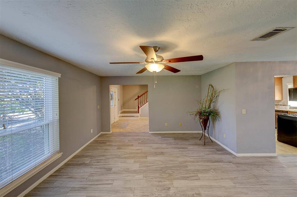 The formal living features designer paint, LVP flooring & an updated fan & light fixture